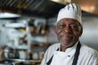 © Baba Images - Portrait of a senior male chef in professional kitchen