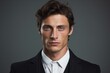 © ORG - Elegant man with delicate eyes against a gray background.