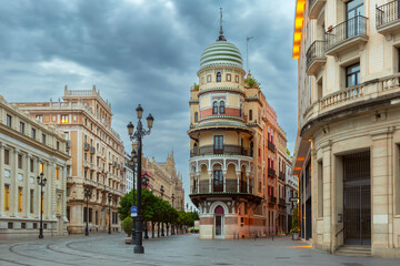 Wall Mural - Old houses on Constitution Avenue in the light of lanterns at dawn, Seville, Andalusia, Spain