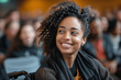 © btiger - Young woman in wheelchair enjoys business presentation in conference hall with audience