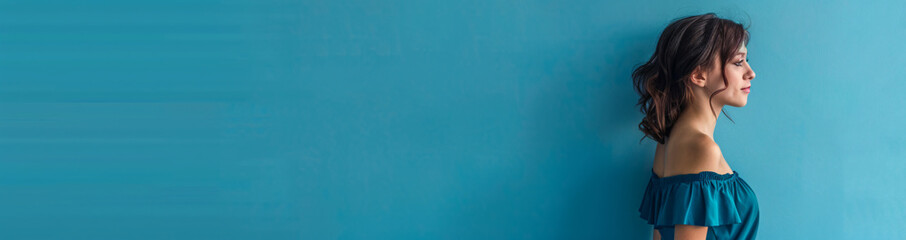 Poster - Photo of A woman in blue dress standing on the right side with copy space area, solid color background. Web banner with copyspace on left


