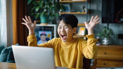 Poster - A young man is sitting in front of a laptop, laughing and celebrating