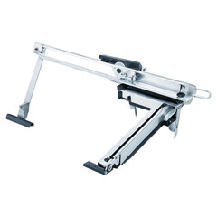 Fototapete - An industrial tool with a polished silver surface designed for precision ting. It has a sy frame a ting edge and a foot pedal for operating it..