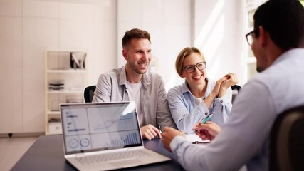 Poster - Young couple discussing their financial future with a Hispanic financial planner