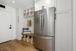 © Wirestock - Modern kitchen interior with a stainless steel refrigerator.