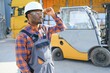 © Serhii - African American Man at work. Professional operation engineering. Young worker forklift driver