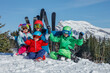 © Sergey Novikov - Mother with kids sitting at a slope, smile, ski on background