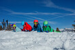 © Sergey Novikov - A group of kids with mother having fun in the snow lay on slope