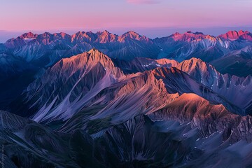 Wall Mural - A panoramic view of a mountain range with curvilinear ridges highlighted by vibrant alpenglow, captured during the magic hour for maximum color impact