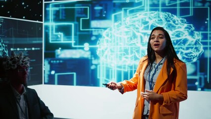Poster - Presenter talking at AI neuroscience forum bringing together IT professionals, showing EEH headset demonstration of latest developments in artificial intelligence mind transfer, camera B