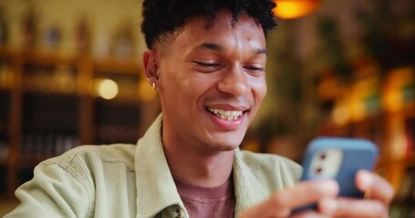 Canvas Print - Happy man, cafe and typing with phone for social media, communication or reading news at indoor restaurant. Male person with smile on mobile smartphone for online chatting or texting at coffee shop