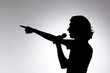 © Thales - Silhouette of young man holding wireless microphone and pointing forward.