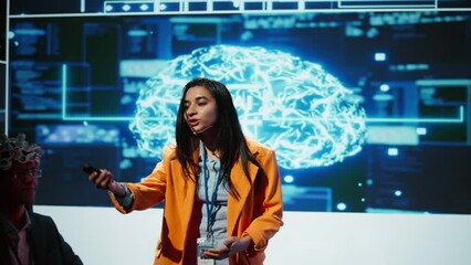 Poster - Speaker does EEG headset presentation during tech convention, demonstrating successful implementation of AI in driving forward startup businesses, sharing latest neuroscience discoveries, camera B
