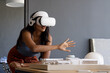 © Wavebreak Media - Using VR headset, woman interacting with architectural model in office, copy space