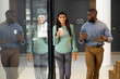 © Wavebreak Media - Business colleagues walking and discussing work, holding coffee and tablet
