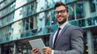 © Ali - portrait of a happy business man using tablet for business management