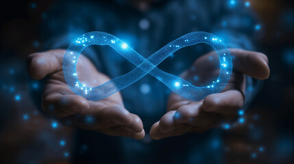 businessman holding glowing blue infinity symbol representing infinite possibilities