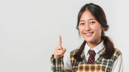 pretty asian woman in university student uniform isolated white background pointing finger to the side