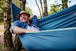 © baranq - Adult man in hammock relaxing