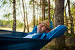 © baranq - Relaxed man smiling in hammock