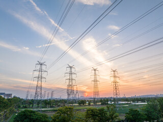 power pylons in field at sunset