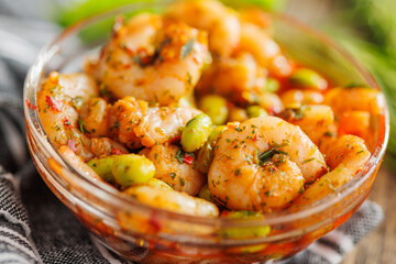 Wall Mural - Fresh salad with shrimps and edamame soybeans in bowl on wooden table.