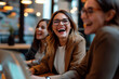 © ty - Excited employees working in office together, happy businesswoman laughing at funny joke