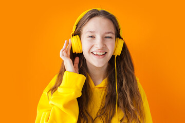 Wall Mural - young woman enjoys great sound in headphones