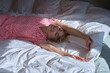 © ADDICTIVE STOCK - Joyful blond woman in pink pajamas relaxing in bed