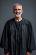 © Lem - A portrait of a smiling middle-aged man wearing a black judicial robe