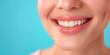© VerraDesigns - Close-up of a woman's perfect white smile on a blue background. Suitable for dental clinics, wellness businesses, healthcare, beauty, and spa industries. Concept of dental health, beauty, and well