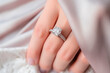 © EricMiguel - Close-up of a diamond ring on a woman's finger, showcasing the elegant and sparkling jewelry in a delicate and romantic setting.