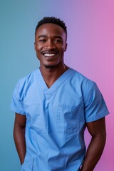 Wall Mural - Smiling African American man in blue scrubs with his hands in his pockets