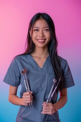 Wall Mural - Portrait of a smiling female dentist holding dental tools