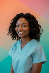 Wall Mural - A portrait of a smiling African American woman wearing a light blue scrub top against a colorful wall.