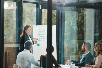 Wall Mural - Woman, whiteboard and presentation with team in boardroom for goals, notes or planning with brainstorming. Coach, training and group with checklist, synergy or collaboration with strategy in office