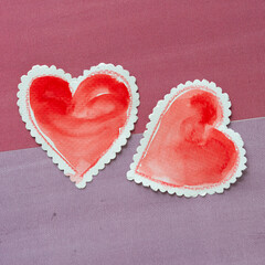 Sticker - close-up of two vintage-styled paper hearts with scalloped edged lacy border on purple