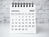 January 2025 white monthly desk calendar on a table