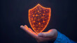 © Anatthaphon - A glowing digital shield floating above a hand, symbolizing cyber security, protection, and data privacy in dark background.