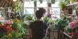 © Omtuanmuda - Woman Admiring Flowers in a Greenhouse