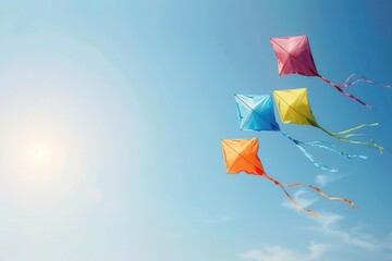 Four colorful kites flying high in a clear blue sky on a sunny day, showcasing a vibrant and joyful outdoor activity.