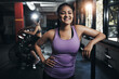 © peopleimages.com - Girl, portrait and smile in gym for fitness, bodybuilding and personal training for health or muscle strength. Female person, arms crossed and proud for active living, exercise and cardio workout.