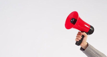 Wall Mural - Hand is hold red megaphone and wear grey suit on white background.