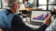 © Plaifah - A financial advisor showing a client a graph on a laptop screen, both looking engaged