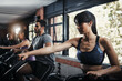© peopleimages.com - People, exercise bike and cycling in gym for workout or leg strength, cardio and muscle endurance for agility training. Recreation center, fitness and machine for cardiovascular, wellness and power.