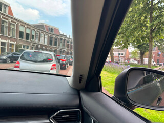 Wall Mural - Cars in traffic jam on city street, view from driver's seat