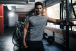 © peopleimages.com - Man, portrait and happy in gym for exercise, bodybuilding and personal training for health or muscle strength. Male person, arms crossed and proud for active living, fitness and cardio workout.