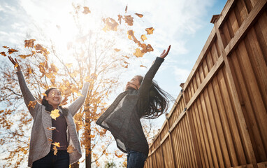 Wall Mural - Fall, leaves or throw with mother and daughter in garden of home together for bonding or love. Family, autumn season or energy with single parent woman and girl child having fun in backyard.