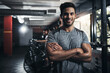 © peopleimages.com - Man, portrait and confident in gym for training, bodybuilding and personal workout for health or muscle strength. Male person, arms crossed and proud for active living, fitness and cardio exercise.