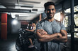 © peopleimages.com - Man, portrait and confident with smile in gym for fitness, bodybuilding and personal training for health or muscle strength. Male person, arms crossed and proud for active living, exercise and cardio